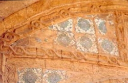Missing colored ornamental ceramic tiles.Deteriorated stone profile. 